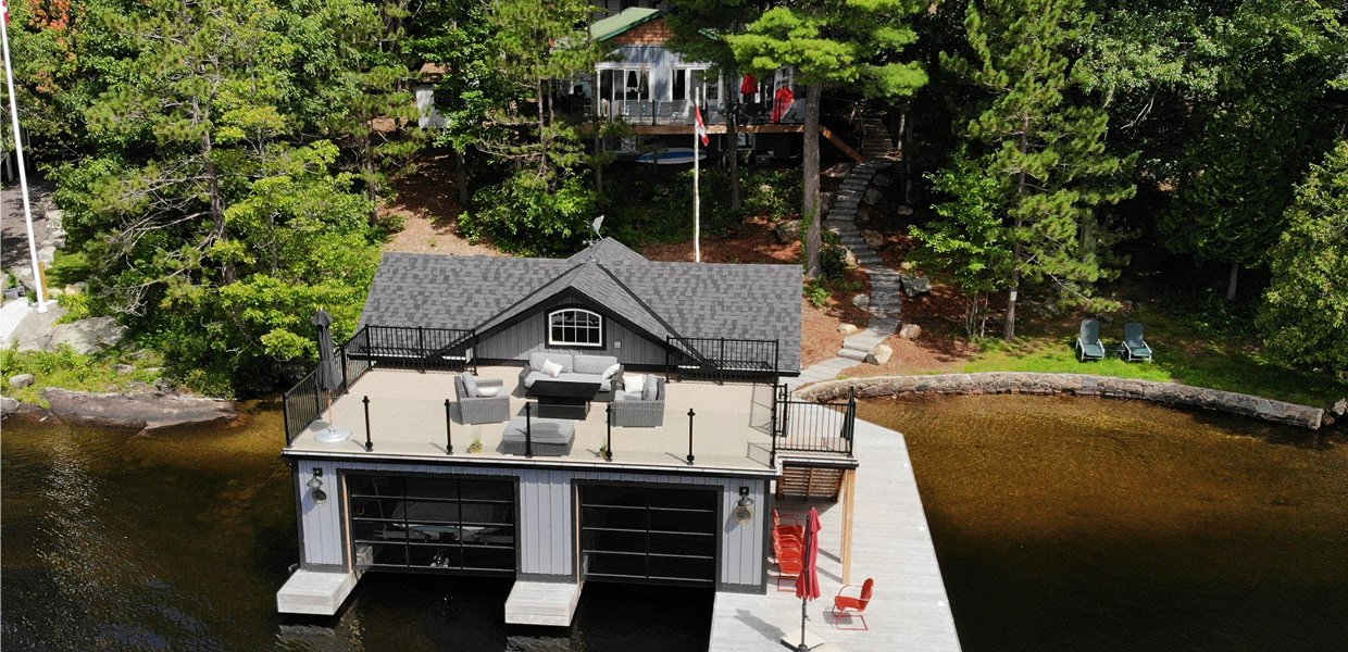 Aerial shot of boathouse wtih sun deck with cottage in background